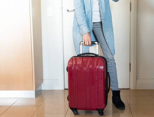 istock Woman with red suitcase 689829034
