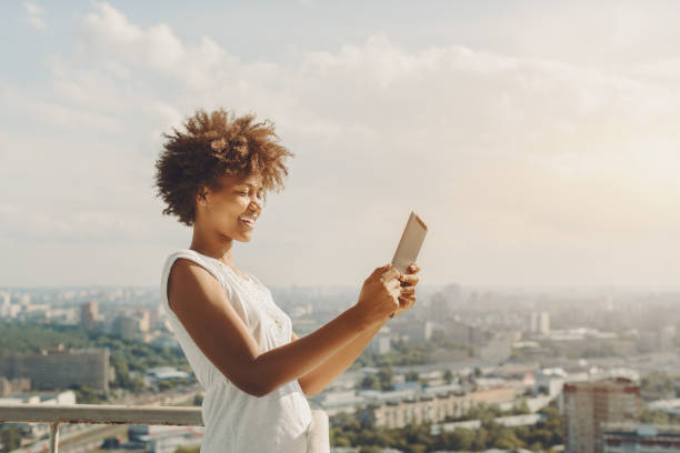 istock Black girl is making selfie on her digital tablet 689829536