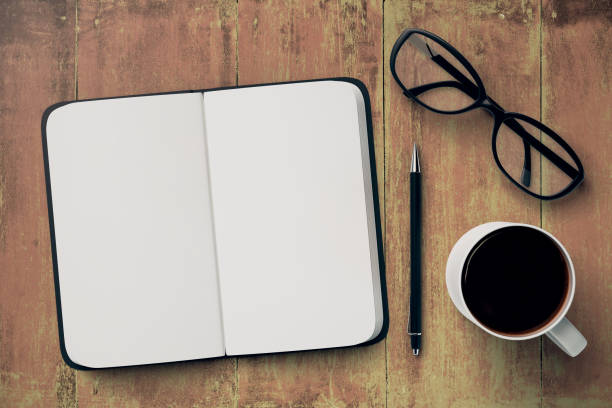 istock Desktop with copybook, mug and glasses 689832150
