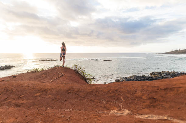 istock Fit young Eurasian woman runs along Hawaii beach on Hawaii beach 689842654