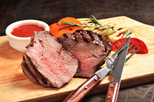 istock Medium Rare Filet mignon steak on wooden board, selected focus 689846068