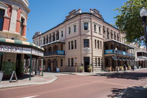 Fremantle,WA,Australia-November 13,2016: The Bar Orient corner architecture with people and cyclist in downtown Fremantle, Western Australia.