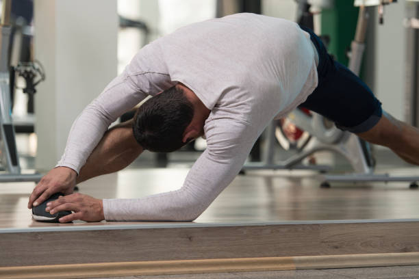 istock Healthy Man Stretches At The Floor 689852602