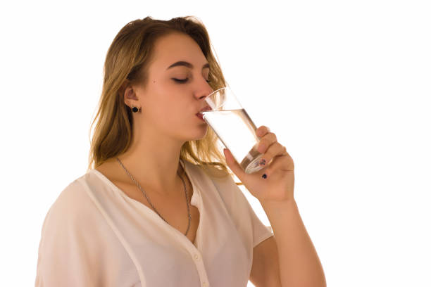 istock Young pretty girl drinks fresh water 689868122