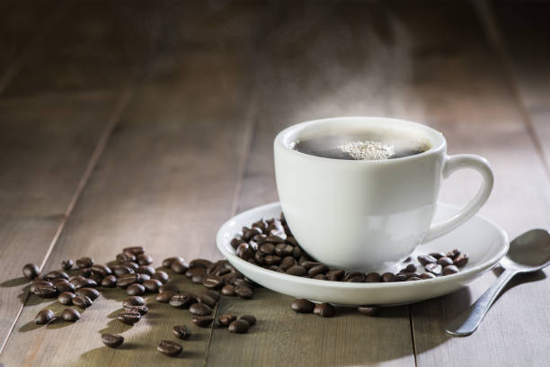 istock hot coffee with smoke on brown wood 689881606