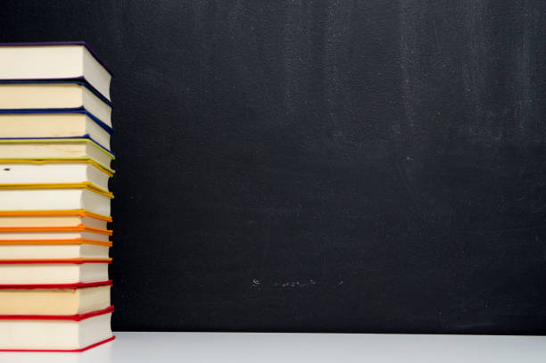 istock pile of colorful books on blackboard background 689882126