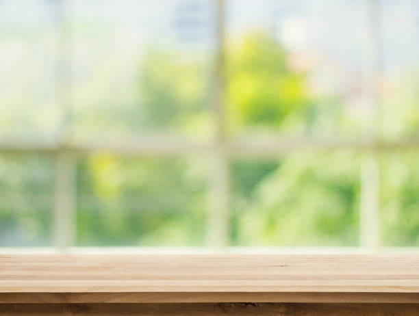 istock Wood table top on white abstract green garden from window 689903456