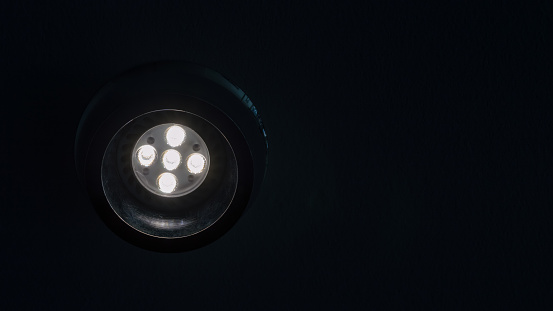 Energy saving led spotlight with flare up in the ceiling in the dark