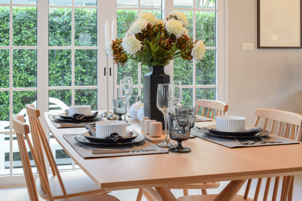 istock wooden table and chairs in dining room with elegant table setting 689911112