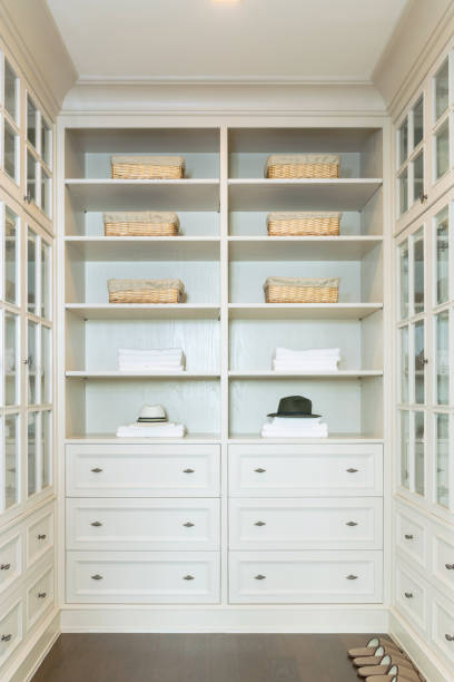 istock large white walk-in closet with shelves at home 689912012