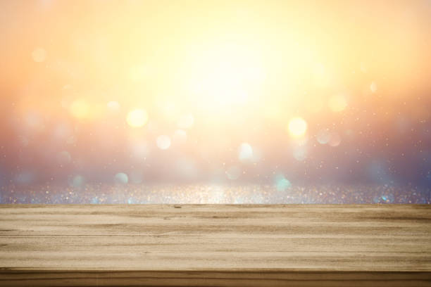 istock Empty table in front of gold and blue glitter lights background 689912026