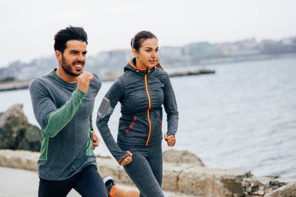 istock Friends jogging by the sea 689912212