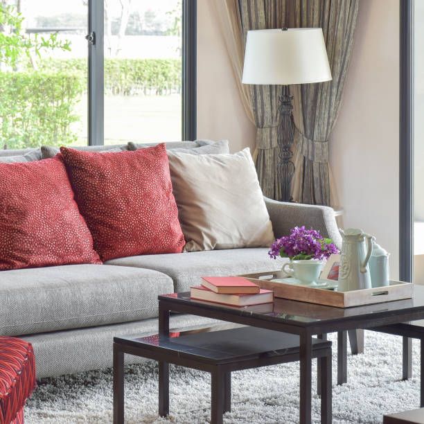istock modern living room design with red pillows on sofa and decorative tea set on table 689919266