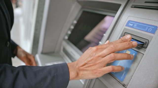 LD Woman stepping to the ATM to make a cash withdrawal