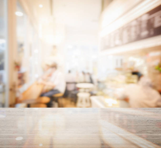 istock granite table top and blur of coffee shop interior as background 689923444