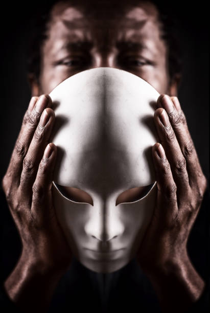 istock Dramatic art portrait of african black man with white mask. 689935654