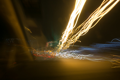Street lights in speeding car in night time, light motion with slow speed shutter.Street lights in speeding car in night time, light motion with slow speed shutter.