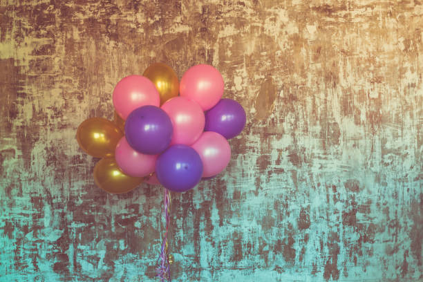 istock Bright balloons bunch against a textured wall 689936464