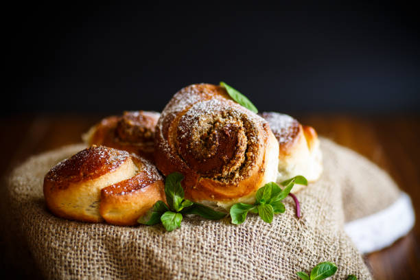 istock Sweet bun with nut filling in powdered sugar 689944436