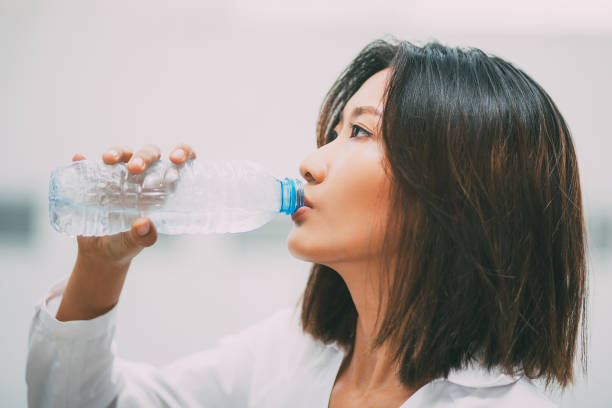istock Asian Woman Drinking Water from Plastic Bottle 689944706