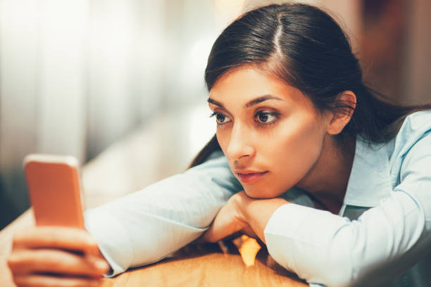 istock Middle-aged Woman Lying on Table with Smartphone 689944752
