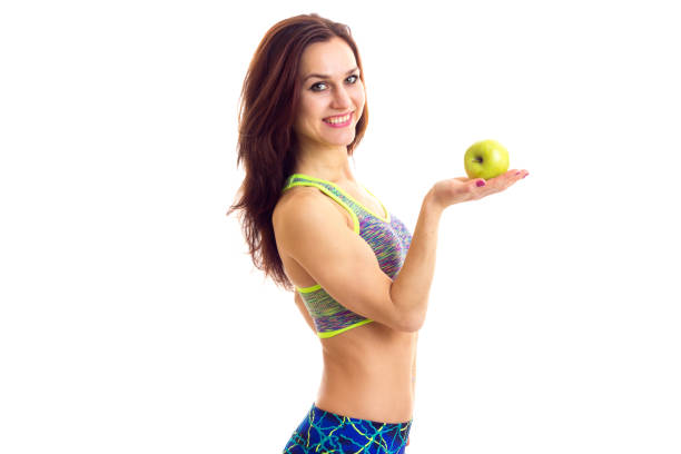 istock Sportive woman holding apple 689947502