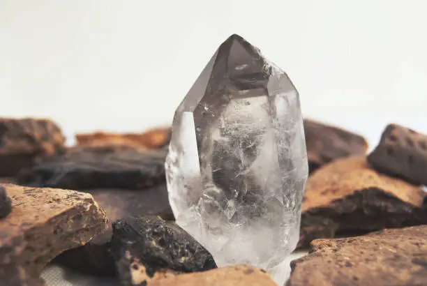 Large quartz crystal on white background close-up.