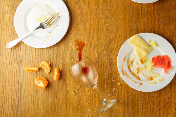 istock Messy table after party. Leftover food, spilled drinks, dirty dishes. 689948062