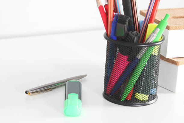 istock Closeup of white desktop with notepads, pen and other items. Selective focus. 689948250