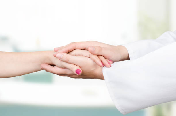 istock Doctor holding patient hand close up 689951222