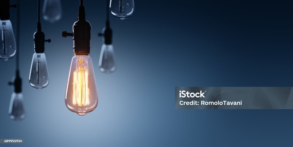 Innovation And Leadership Concept - Glowing Bulb lamp Glowing Bulb On Among Bulbs Off Light Bulb Stock Photo