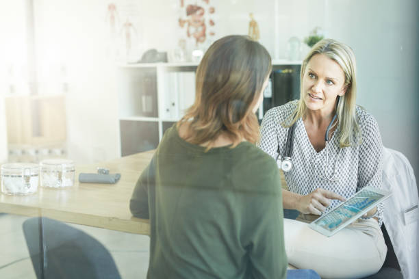 I have a few referrals here for you Cropped shot of a female doctor showing her patient something on her digital tablet medical insurance data stock pictures, royalty-free photos & images