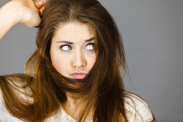istock Woman having face covered with her brown hair 689959846