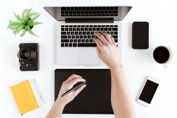 istock top view of hands using graphic tablet and laptop at modern workplace 689963574