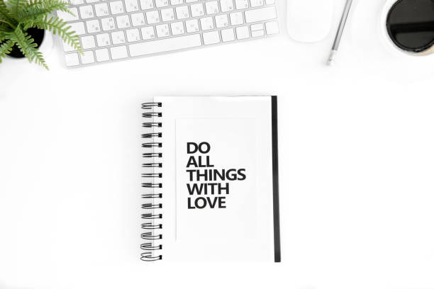 istock flat lay with do all things with love motivational quote in diary, computer mouse and keyboard isolated on white 689967206