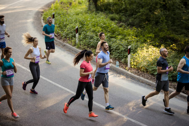 istock High angle view of marathon runners on a road. 689967844