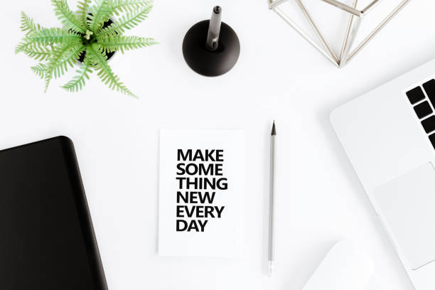 istock flat lay with Make something new everyday motivational quote on modern workplace with wireless devices 689967950