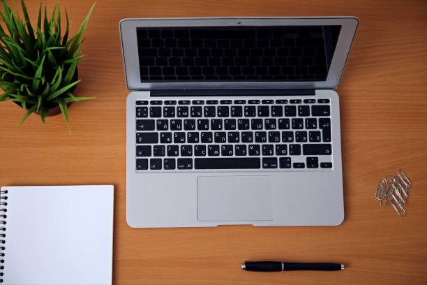 istock Office table with laptop, notepad and coffee cup. View from above with copy space 689968094