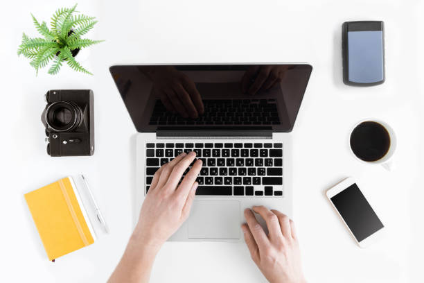istock top view of hands typing on laptop at modern workplace 689968382