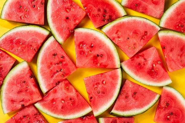 istock Beautiful pattern with fresh watermelon slices on yellow bright background. Top View. 689970534