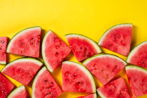 istock Beautiful pattern with fresh watermelon slices on yellow bright background. Top View. 689970554