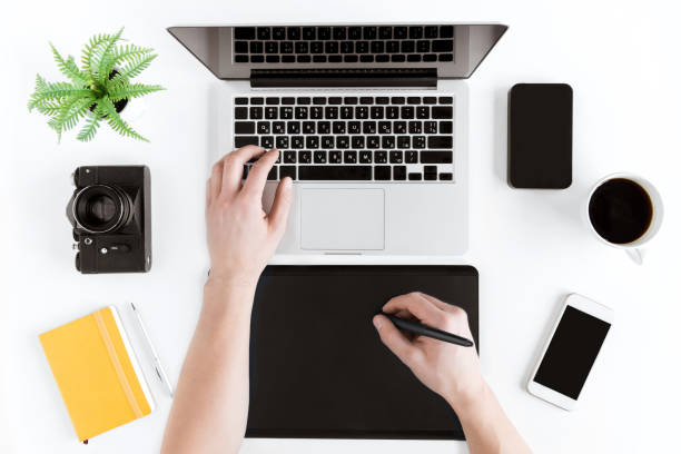 istock top view of hands using graphic tablet and laptop at workplace 689970650