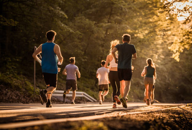 istock Rear view of runners during a marathon race at sunset. 689971010