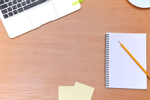 istock Office table with laptop, notepad and coffee cup. View from above with copy space 689971300