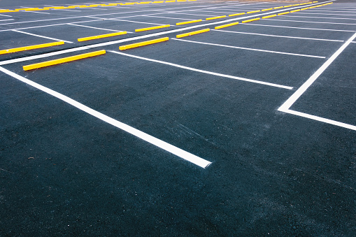 Empty parking lot in front of a cityscape