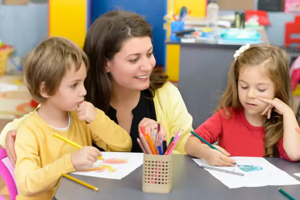 Photo of Kids and Educator Playing at Kindergarten