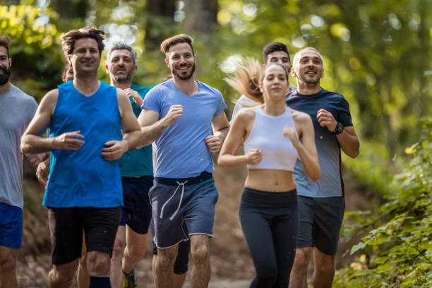 istock Group of people running a marathon race in nature. 689972084