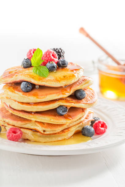 istock Sweet american pancakes with maple syrup and berries 689974306