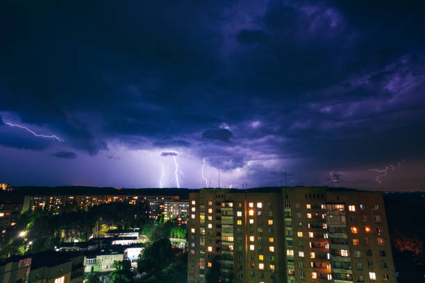 istock Thunderstorm and lightning over a town at night. 689975534