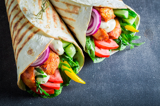 Tasty grilled tortilla with chicken, tomatoes and lettuce